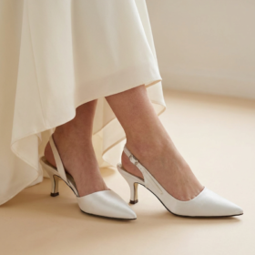 Bride wearing white satin Pink Paradox bridal shoes in UK size 3